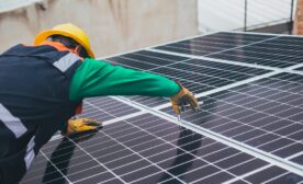 Free Solar Technician Installing Solar Panel Stock Photo