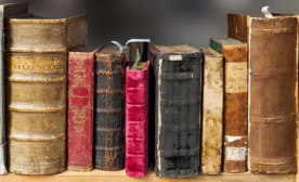 Closeup of very old books on a shelf